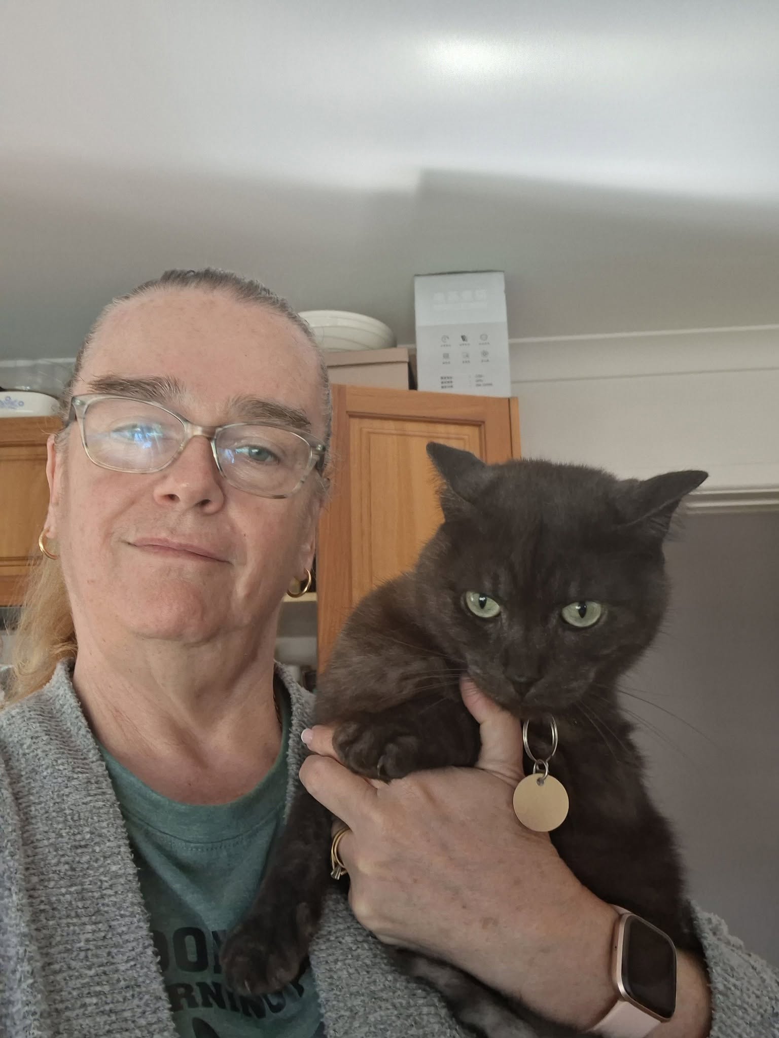 A person holding Shadow, a black cat